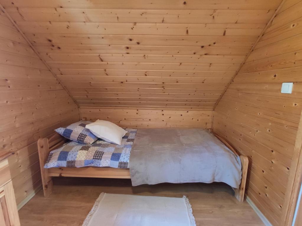 Posteľ alebo postele v izbe v ubytovaní Domek letniskowy Arkady