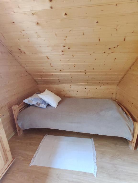Posteľ alebo postele v izbe v ubytovaní Domek letniskowy Arkady