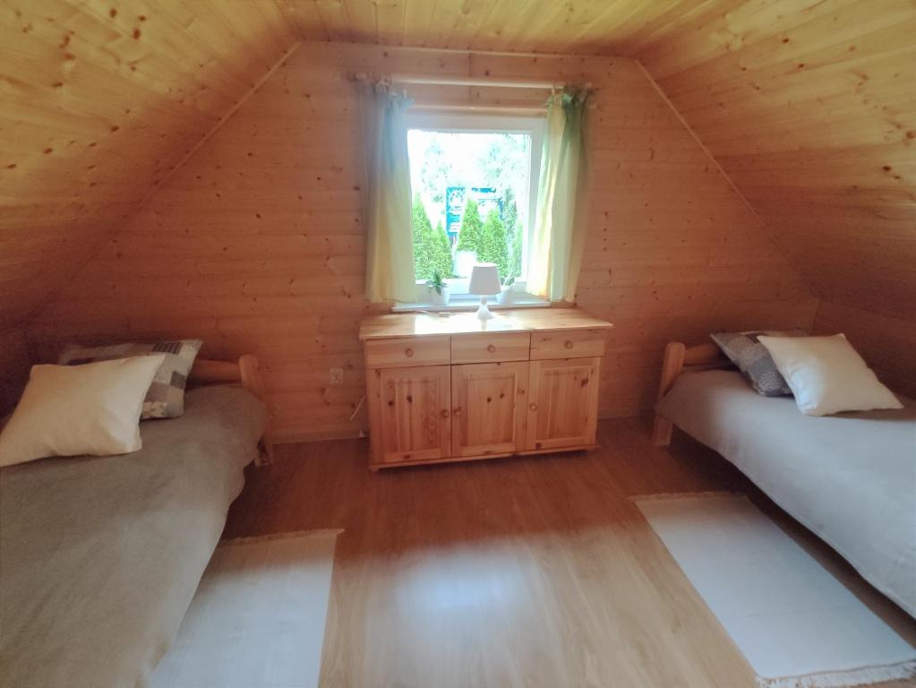 Posteľ alebo postele v izbe v ubytovaní Domek letniskowy Arkady