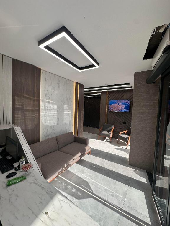 a living room with a couch and a television at Luxury Life Suites in Istanbul