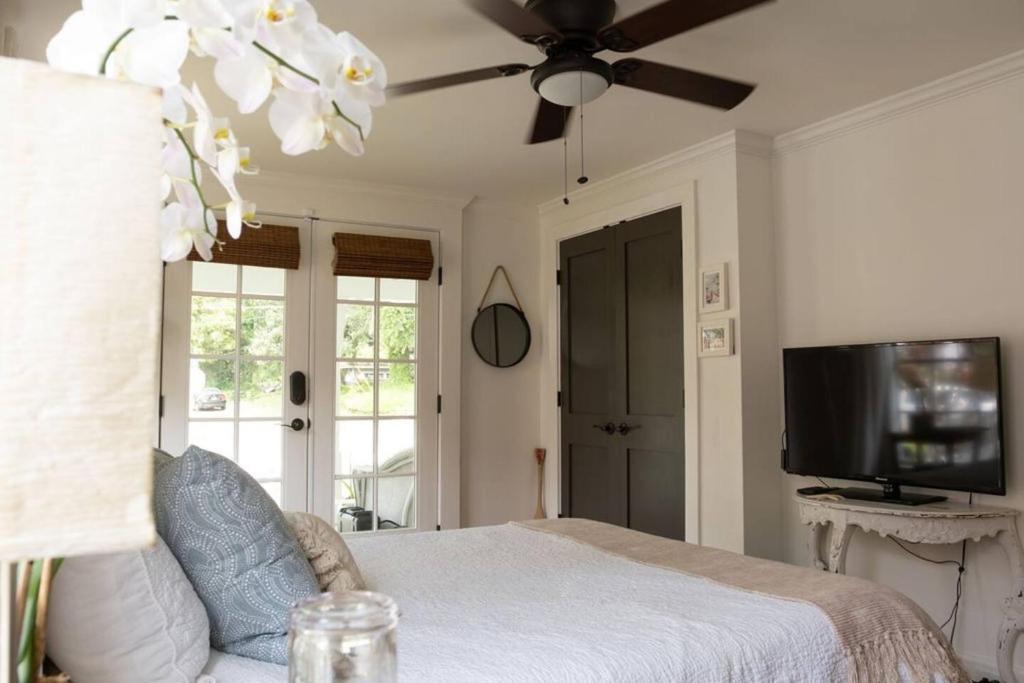 a bedroom with a bed and a ceiling fan at Historic Coastal Suite Steps to the Water - Suite One in Fairhope
