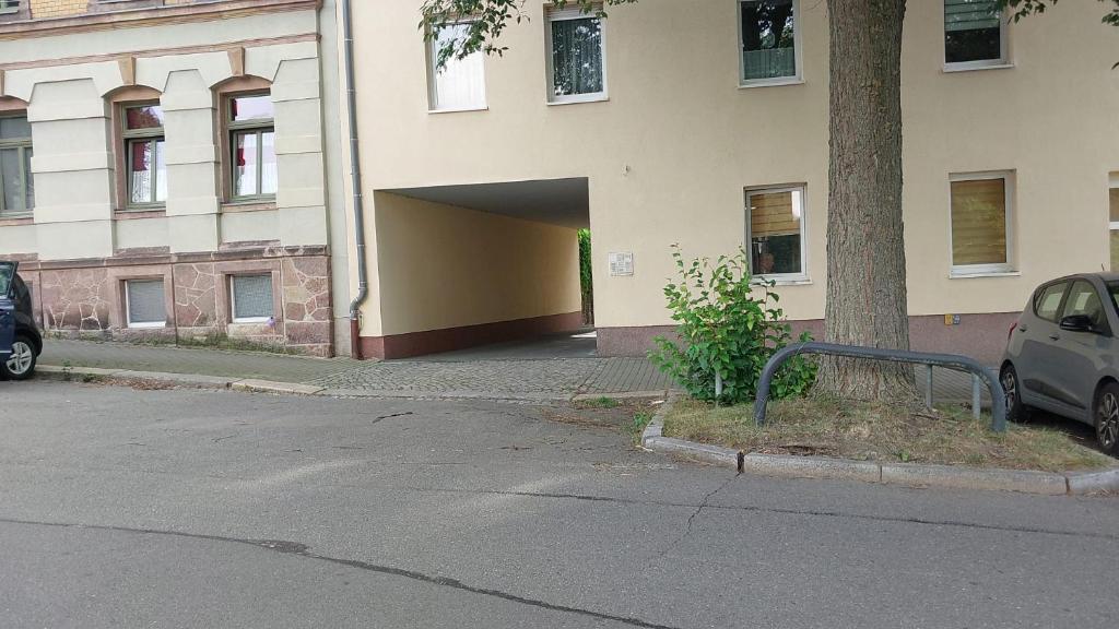 un edificio con un'auto parcheggiata in un parcheggio di Ferienwohnungen Augustusburger Straße 149 a Chemnitz