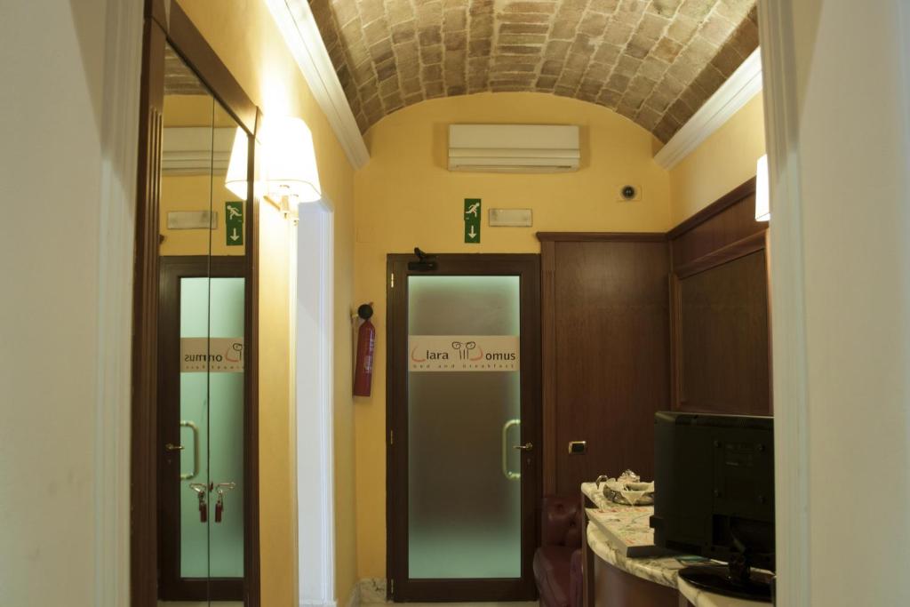 a bathroom with two glass doors in a room at Clara Domus in Rome