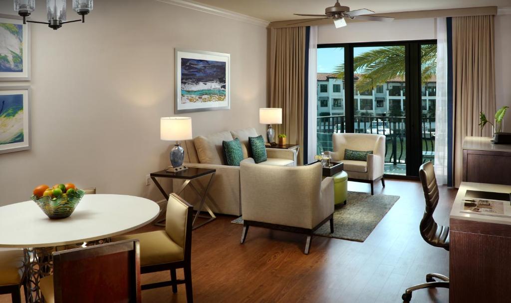 a living room with a couch and a table at Naples Bay Resort and Marina in Naples
