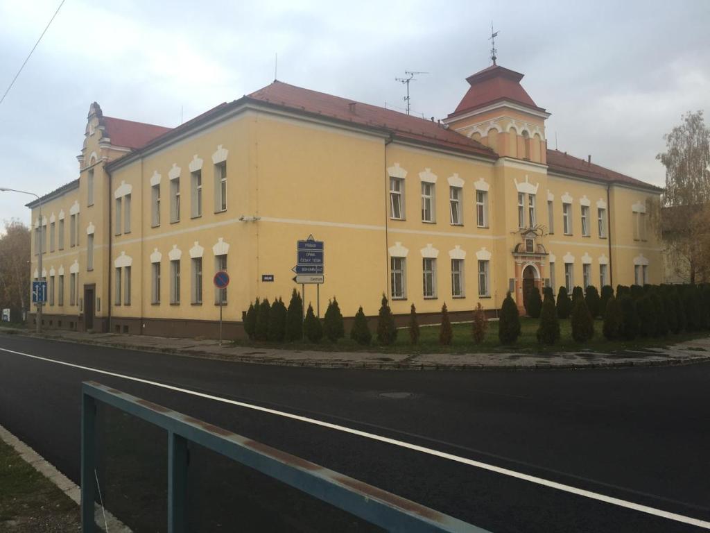a large yellow building on the side of a road at Hostel Karin in Ostrava