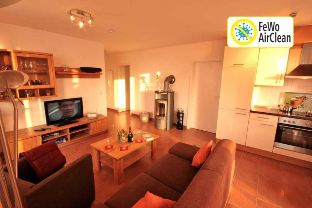 a living room with a couch and a table at Meerblick 5 - Großenbrode in Grossenbrode