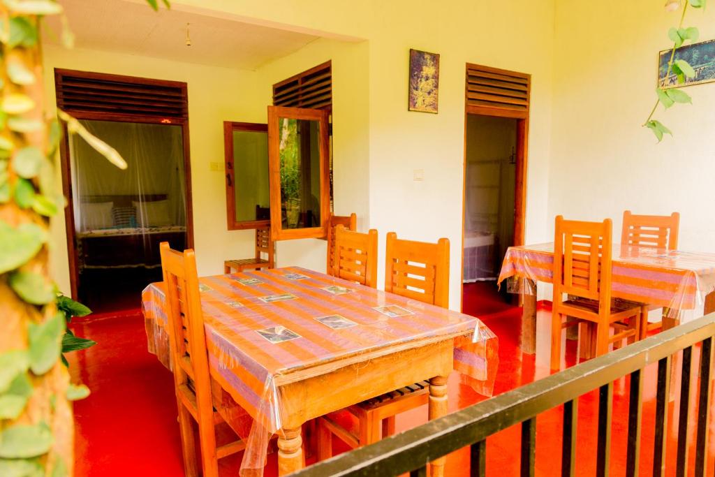 a dining room with wooden tables and chairs at Aroma Heaven Homestay in Ella