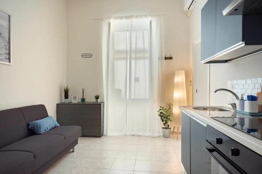 a living room with a couch and a kitchen at Spagno li's House in Naples