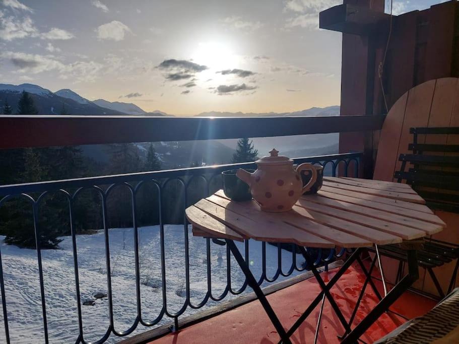 a tea pot sitting on a table on a balcony at Appartement Arcs 1800 Les Villards 5 personnes in Bourg-Saint-Maurice
