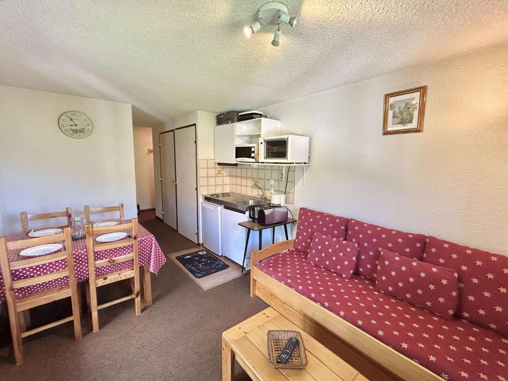 un salon avec un canapé rouge et une cuisine dans l'établissement Charmant T2 à Demi-Quartier, 1 chambre, balcon, parking, casier à skis, proche forêt et espaces verts - FR-1-597-32, à Demi-Quartier