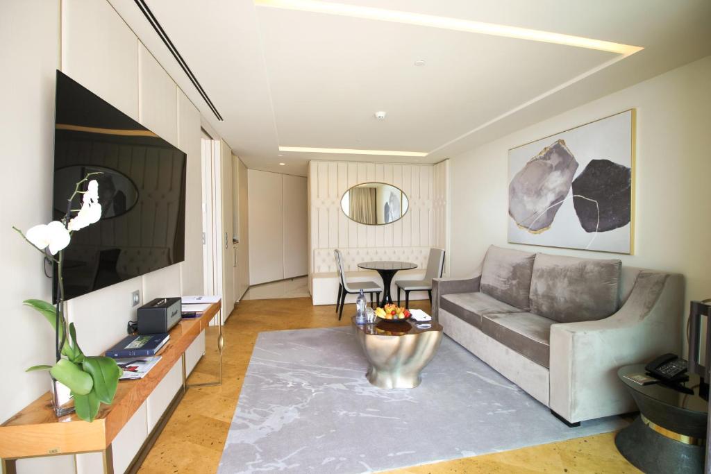 a living room with a couch and a table at Savoy Palace - The Leading Hotels of the World - Savoy Signature in Funchal