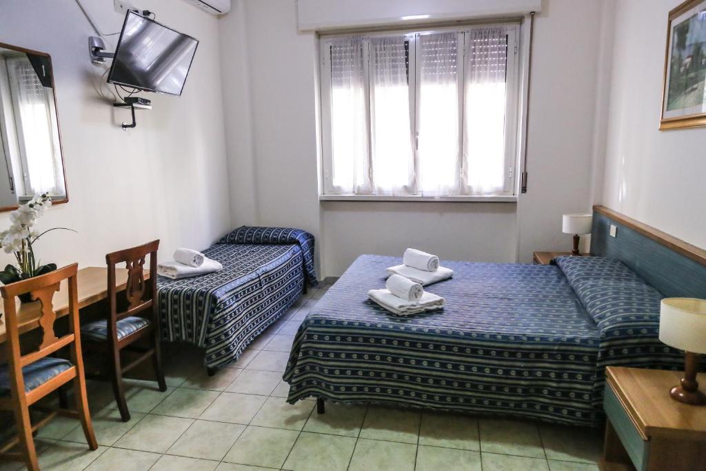 Postel nebo postele na pokoji v ubytování Albergo Athena