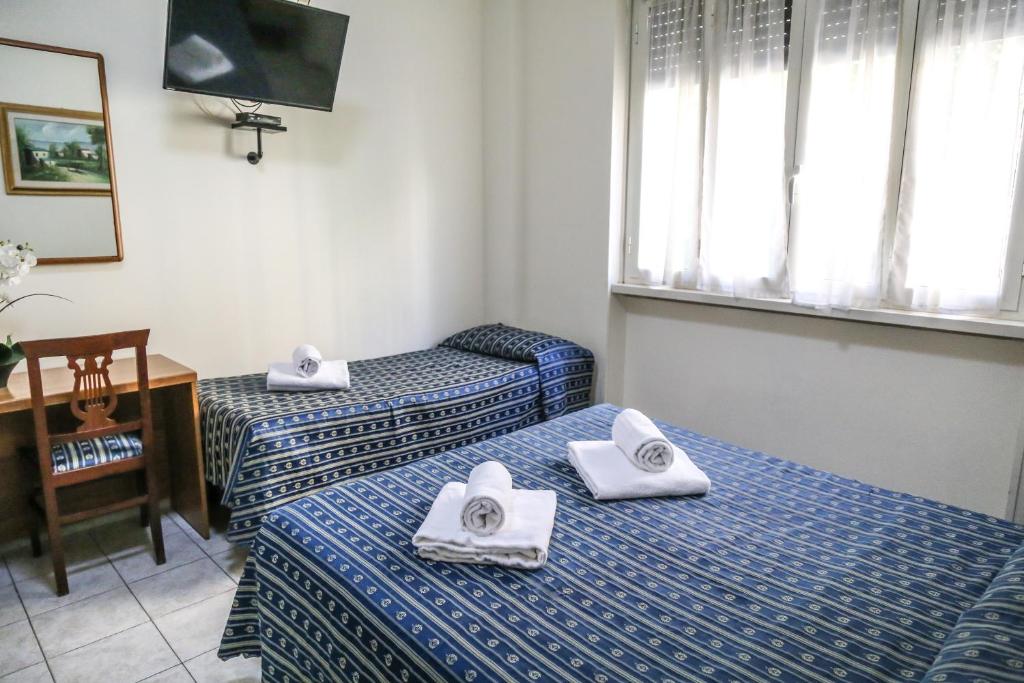 Postel nebo postele na pokoji v ubytování Albergo Athena