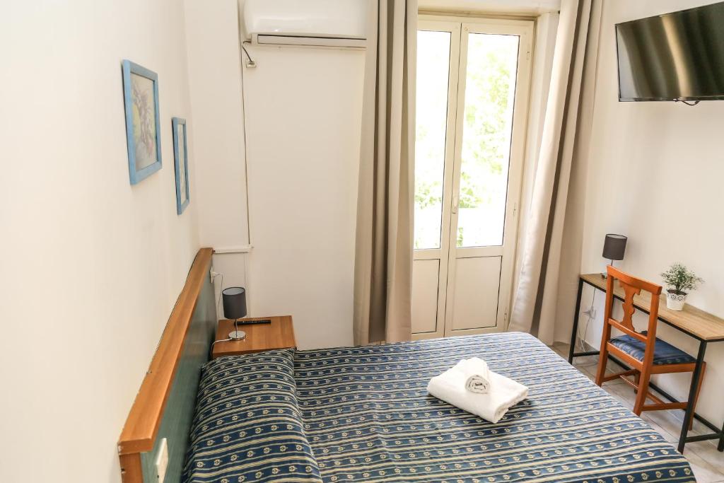 Postel nebo postele na pokoji v ubytování Albergo Athena