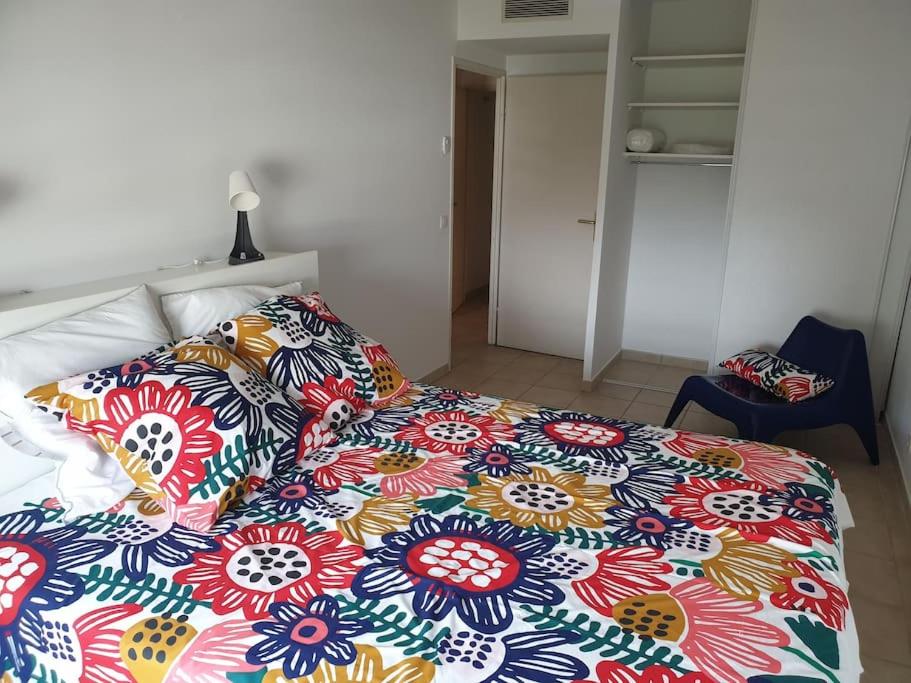 - un lit avec une couverture colorée dans l'établissement Spacieux logement Prado Rabateau idéal Famille, à Marseille