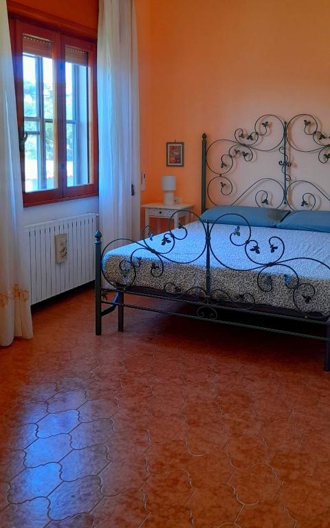 a bedroom with a bed with a blue comforter at Il Corniolo in Tarquinia