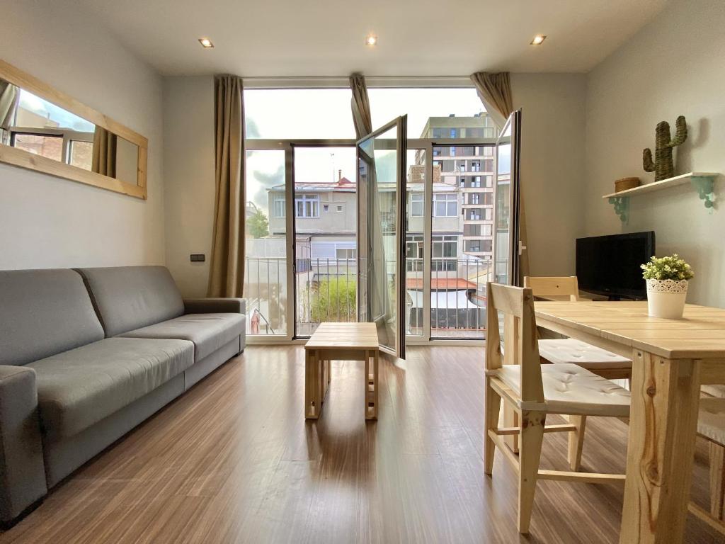 a living room with a couch and a table at Loft Pere IV in Barcelona