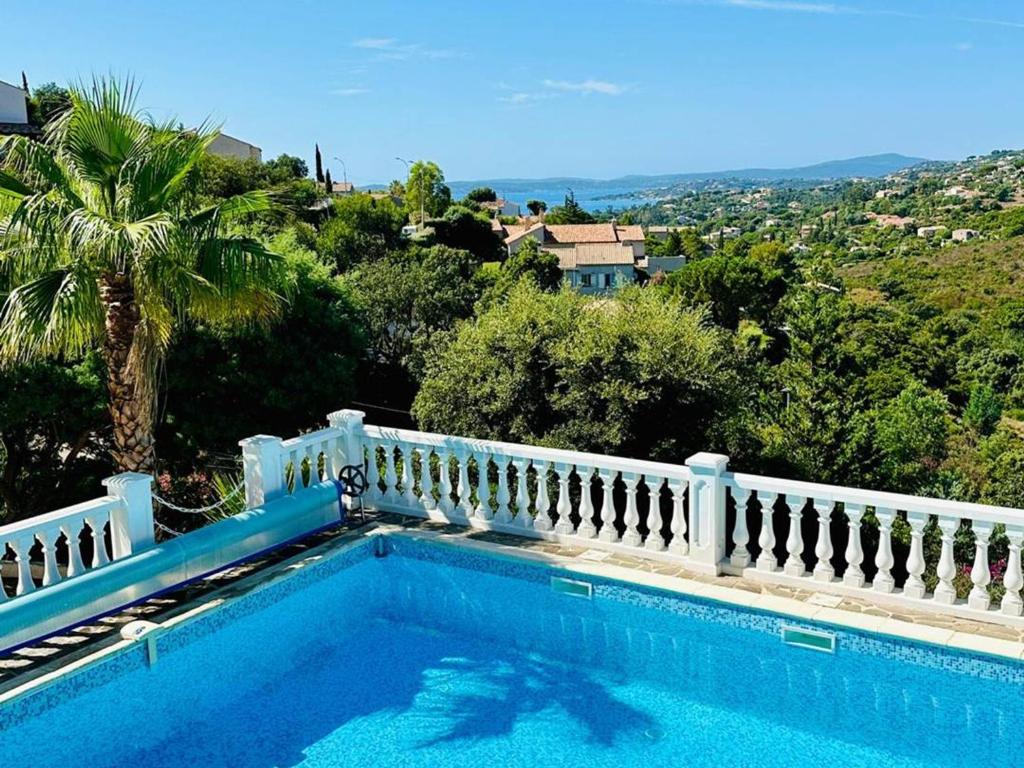 a swimming pool in front of a white fence at Villa moderne 6 CH pour 12 avec piscine privée, clim et parking aux Issambres - FR-1-768-24 in Les Issambres