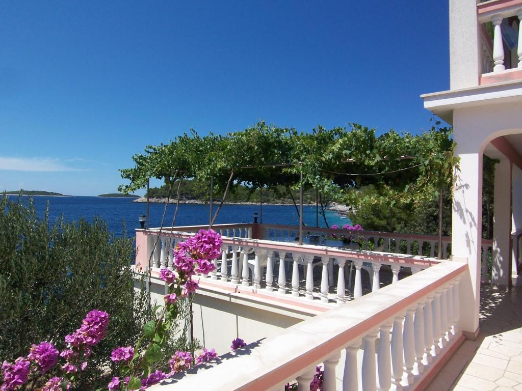 a balcony of a house with a view of the water at Apartmani Mašković in Prizba