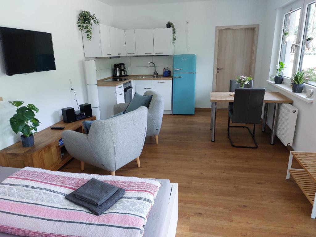 ein Wohnzimmer mit einer Küche und einem Tisch mit Stühlen in der Unterkunft Ferienwohnung Moselliebe in Lehmen