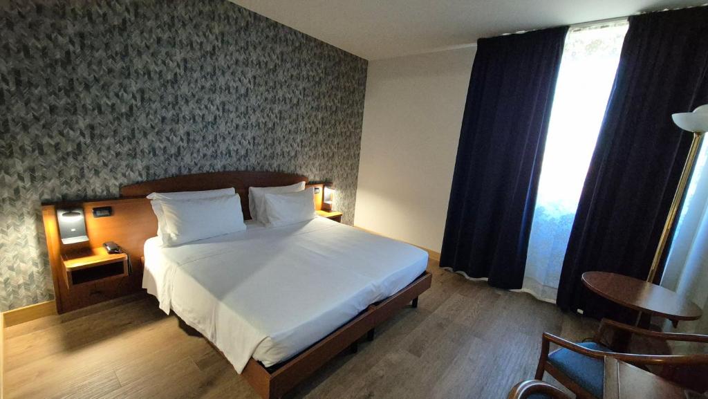 Postel nebo postele na pokoji v ubytování Hotel Le Cerbaie