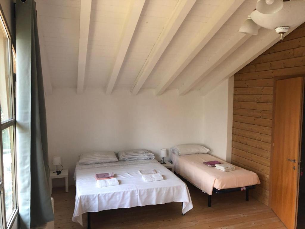 Posteľ alebo postele v izbe v ubytovaní Oasi Franciacorta