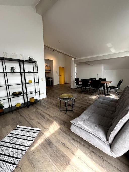 a living room with a couch and a table at Moderne Wohnung mit Dachterrasse in Groß-Umstadt