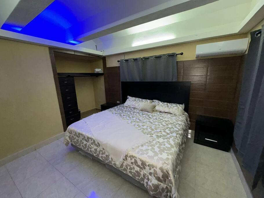 a bedroom with a bed with a white comforter at Conveniente departamento en zona centro planta baja in Reynosa