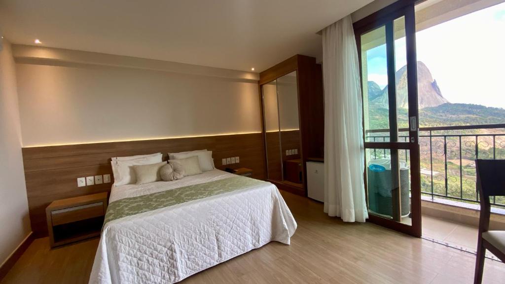 Ένα ή περισσότερα κρεβάτια σε δωμάτιο στο Vista Azul Apart Hotel - Vista Pedra