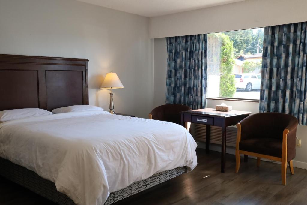 Postel nebo postele na pokoji v ubytování Skylite Motel