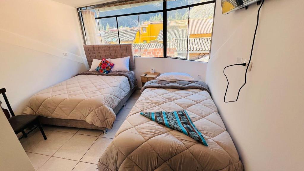 Postel nebo postele na pokoji v ubytování intikilla hostal