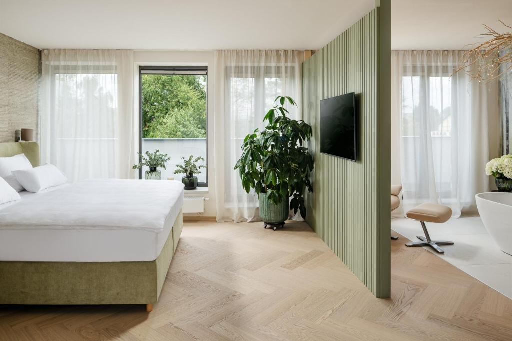 Postel nebo postele na pokoji v ubytování HERBARIUM boutique hotel