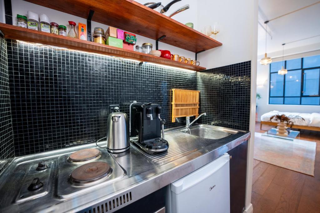 a kitchen with a sink and a counter top at Heart of The City in Auckland