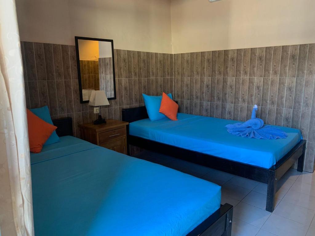 Postel nebo postele na pokoji v ubytování Lita Homestay