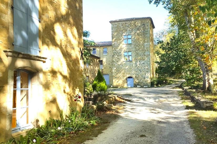 an old stone building next to a street at Le Castillou in Luc-sur-Aude