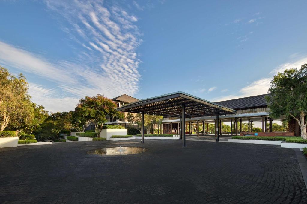 a building with a pavilion in the middle of a parking lot at Radisson Blu Bali Uluwatu in Uluwatu