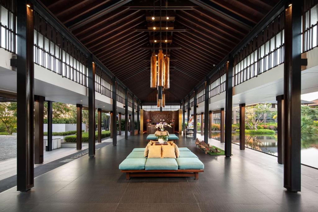 a large room with two beds in it at Radisson Blu Bali Uluwatu in Uluwatu
