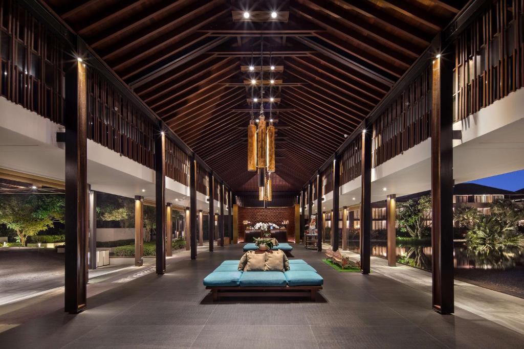 a large building with two beds in the middle at Radisson Blu Bali Uluwatu in Uluwatu