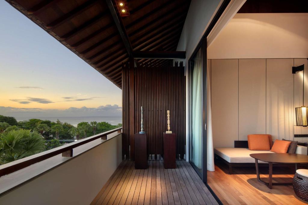 a balcony with a view of the ocean at Radisson Blu Bali Uluwatu in Uluwatu