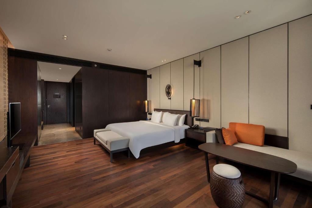 a hotel room with a bed and a couch at Radisson Blu Bali Uluwatu in Uluwatu