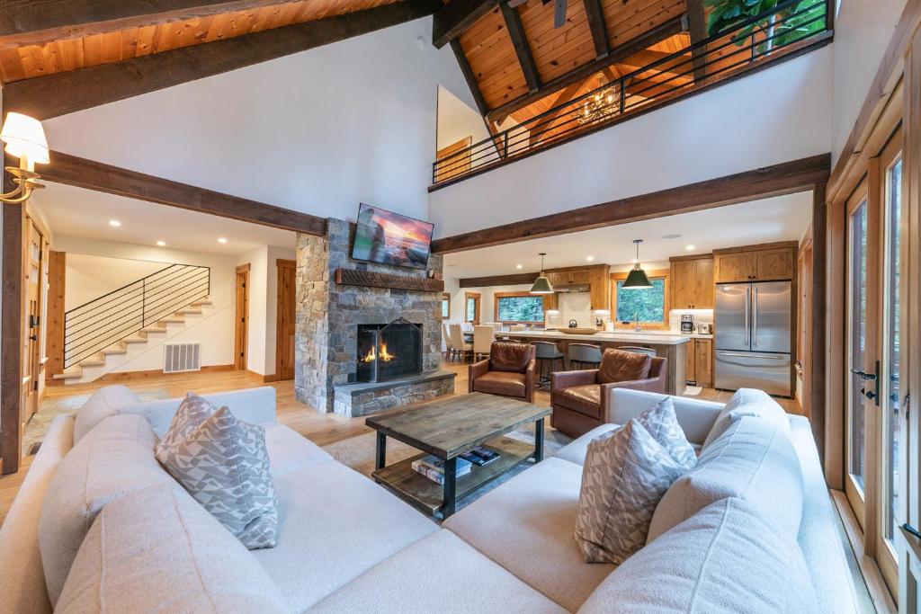 a living room with a couch and a fireplace at Eclipse Retreat at Tahoe Park - Hot Tub - Fenced Yard & steps to HOA Access in Tahoe City