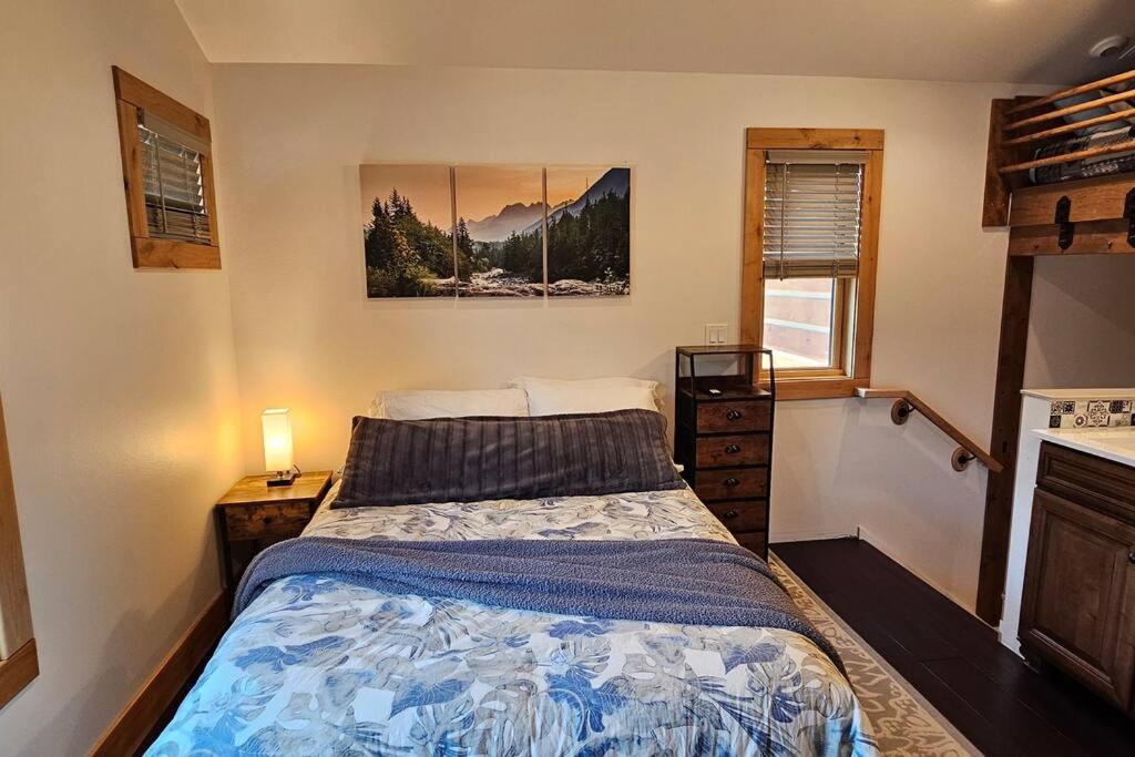 a bedroom with a bed and a picture on the wall at Beautiful Riverfront Near Mt Bachelor with Hot Tub in Bend