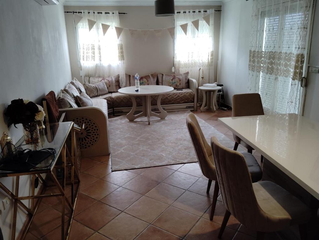 una sala de estar con un sofá y una mesa en L'échappée belle 95, en Goussainville