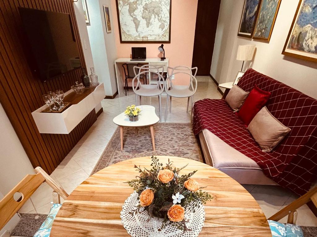 a living room with a couch and a table at Apartamento Beira Mar Praia da Costa in Vila Velha