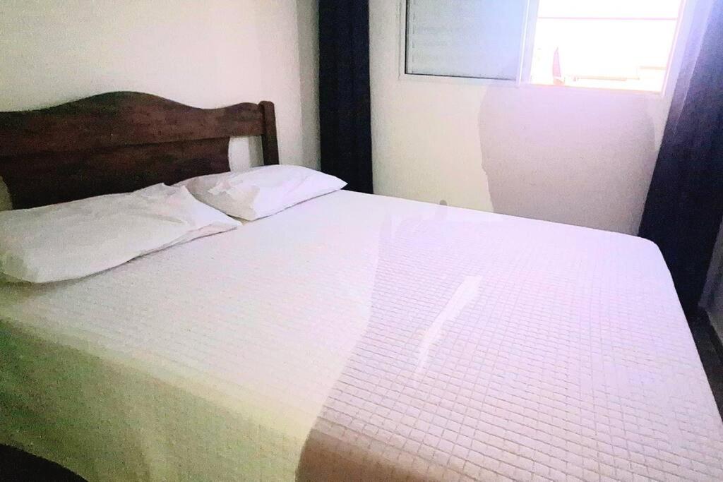 Ένα ή περισσότερα κρεβάτια σε δωμάτιο στο Village planalto verde