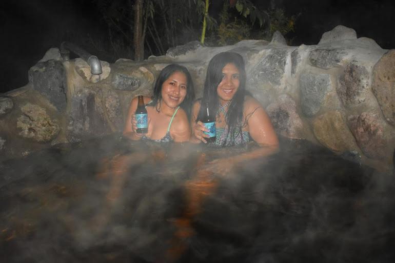 two women are sitting in a hot tub at El Huayllar in Cusco