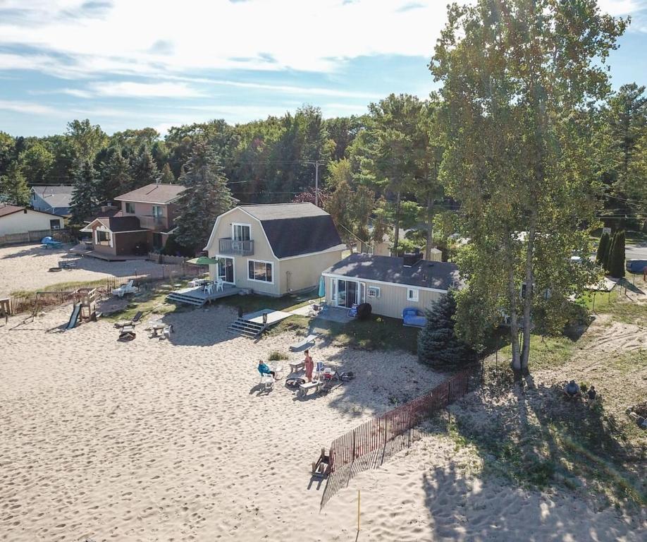 an aerial view of a house on a beach at Beach Club of Oscoda - All 4 Beachfront Cottages in Oscoda