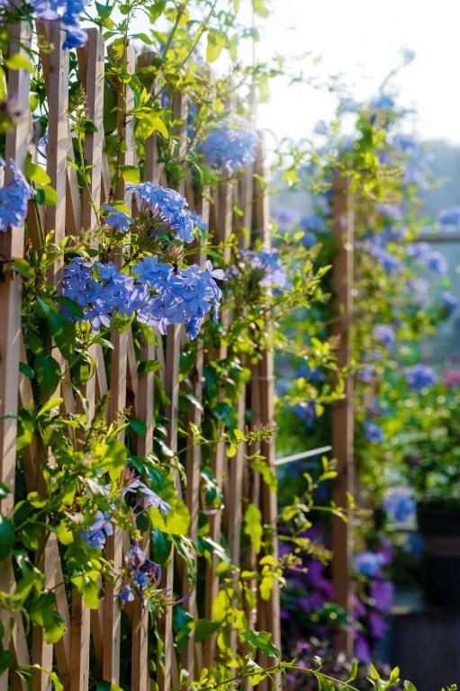 a wooden fence with blue flowers on it at Wuyu Hotel - Chongqing Jiangbei Airport & Light Rail in Chongqing