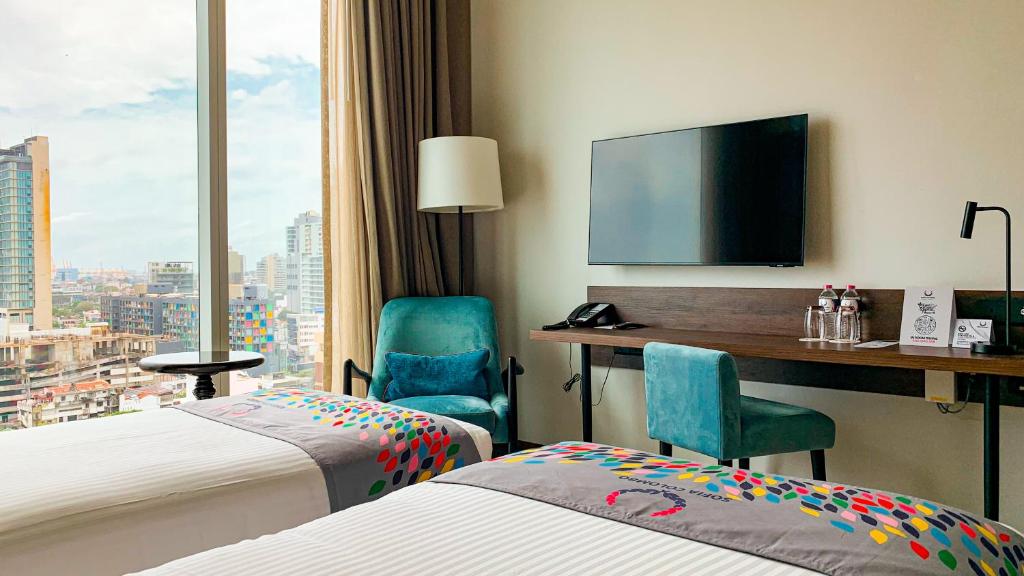 Postel nebo postele na pokoji v ubytování Sofia Colombo City Hotel