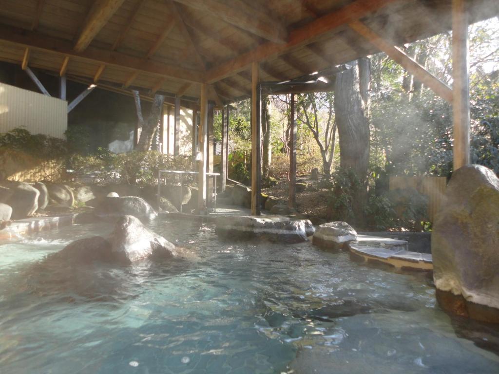 a pool of water with rocks in front of a building at Yoshimatsu in Hakone